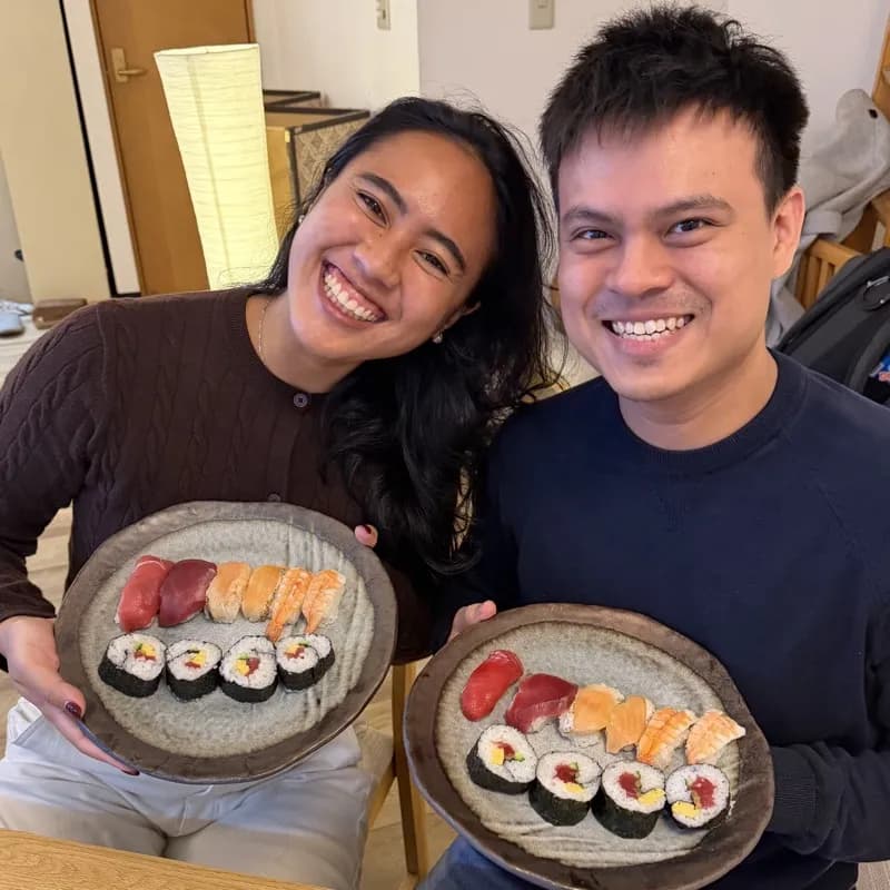 Happy couple showing their handmade sushi plates